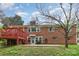 The backyard features a red deck with stairs, with a partial view of the red brick home at 2714 Dogwood Cir, Charlotte, NC 28208