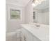 Bright bathroom with white vanity, countertop, new fixtures, and a toilet at 2714 Dogwood Cir, Charlotte, NC 28208