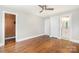 Bedroom featuring hardwood floors, modern ceiling fan, and access to a bathroom at 2714 Dogwood Cir, Charlotte, NC 28208