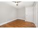 Bedroom featuring hardwood floors, neutral walls, and a door at 2714 Dogwood Cir, Charlotte, NC 28208