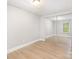 Bright bedroom features sleek wood floors, mirrored closet doors, and a window view at 2714 Dogwood Cir, Charlotte, NC 28208