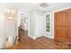 Inviting foyer with hardwood floors, natural light, and a glimpse into a bright kitchen at 2714 Dogwood Cir, Charlotte, NC 28208