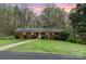 Charming brick home with a well-manicured front yard and mature trees at 2714 Dogwood Cir, Charlotte, NC 28208