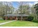 Charming one-story brick home with a well-manicured front lawn and mature trees at 2714 Dogwood Cir, Charlotte, NC 28208