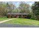 A brick home features a welcoming walkway leading to the front door, set against a green lawn at 2714 Dogwood Cir, Charlotte, NC 28208