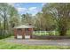 Rear of brick home with garage and basketball court at 2714 Dogwood Cir, Charlotte, NC 28208