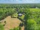 Beautiful brick home surrounded by a lush green landscape with wooded and open areas at 2805 Sadler Rd, Alexis, NC 28006