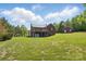 Expansive backyard with a brick house featuring a large wooden deck and detached garage at 2805 Sadler Rd, Alexis, NC 28006