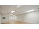 Finished basement featuring hardwood floors, bright lighting, and white walls at 2805 Sadler Rd, Alexis, NC 28006