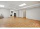 Finished basement with hardwood floors, utility equipment, and ample lighting at 2805 Sadler Rd, Alexis, NC 28006