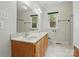 Well-lit bathroom with dual sinks and shower-tub combo at 2805 Sadler Rd, Alexis, NC 28006