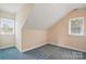 Cozy bedroom featuring two windows, neutral walls, and blue carpet at 2805 Sadler Rd, Alexis, NC 28006
