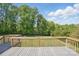 A spacious deck overlooking a well-maintained green lawn and a lush, wooded area at 2805 Sadler Rd, Alexis, NC 28006