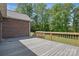 Wide wooden deck extending from a brick house, providing an outdoor space with views of greenery at 2805 Sadler Rd, Alexis, NC 28006