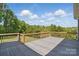 An expansive wooden deck with railings, offering scenic views of the surrounding trees and sky at 2805 Sadler Rd, Alexis, NC 28006