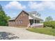 Side view of a brick home with a covered porch and ample parking space at 2805 Sadler Rd, Alexis, NC 28006