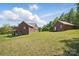 Brick house and additional garage on a sprawling lawn under a blue sky with wispy clouds at 2805 Sadler Rd, Alexis, NC 28006