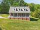 Charming brick home with a covered front porch, dormer windows, and lush green lawn at 2805 Sadler Rd, Alexis, NC 28006