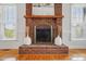 Close-up of a traditional brick fireplace with mantel and hearth at 2805 Sadler Rd, Alexis, NC 28006