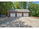 Spacious three-car detached garage with white doors and a concrete driveway at 2805 Sadler Rd, Alexis, NC 28006