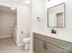 Bathroom features a modern vanity and fixtures, complemented by tile flooring and a laundry area at 3210 Selwyn Farms Ln # 7, Charlotte, NC 28209