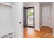 Bright entryway with wooden floors, showing coat closet and a front door with decorative glass at 3210 Selwyn Farms Ln # 7, Charlotte, NC 28209
