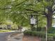Street view of Hunters Run community sign surrounded by lush trees at 3210 Selwyn Farms Ln # 7, Charlotte, NC 28209