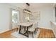 Modern dining room with six chairs, contemporary lighting, and a serene painting for a calm ambiance at 3210 Selwyn Farms Ln # 7, Charlotte, NC 28209