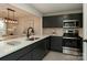 Modern kitchen features sleek dark cabinets, quartz countertops, and stainless steel appliances at 3210 Selwyn Farms Ln # 7, Charlotte, NC 28209