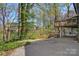 Home with a tiered backyard, featuring lush greenery, a wooden deck, and a tranquil setting at 3846 22Nd Ne St, Hickory, NC 28601