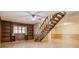 Basement rec room with laminate floors, open shelving, and a staircase at 3846 22Nd Ne St, Hickory, NC 28601