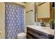Bathroom featuring wood style vanity, brushed bronze fixtures and leaf patterned shower curtain at 3846 22Nd Ne St, Hickory, NC 28601