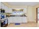 Bright kitchen features white cabinets, modern appliances and a window with a view to the back yard at 3846 22Nd Ne St, Hickory, NC 28601