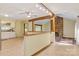 Open-concept living space with brick fireplace, wood floors, and a view into the kitchen at 3846 22Nd Ne St, Hickory, NC 28601