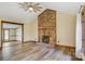 Spacious living room with a brick fireplace, wood floors, and natural light from the windows at 3846 22Nd Ne St, Hickory, NC 28601
