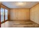 Bright living room boasts wood-paneled walls, textured ceilings, and sleek floors, enhanced by natural light from the sliding glass doors at 3846 22Nd Ne St, Hickory, NC 28601