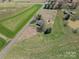 Birds-eye view of a home with a pond and bordering farmland at 396 Tower Rd, Vale, NC 28168