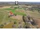 Aerial view showcasing the property's location on route 27 with scenic countryside and pond at 396 Tower Rd, Vale, NC 28168