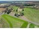 Aerial view featuring the home, a pond, and lush green fields on a sunny day at 396 Tower Rd, Vale, NC 28168