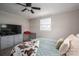 Relaxing bedroom with natural light, neutral tones, and a ceiling fan for optimal comfort at 396 Tower Rd, Vale, NC 28168