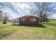 Brick exterior with a well-maintained lawn and an attached sunroom, offering a serene outdoor view at 396 Tower Rd, Vale, NC 28168