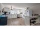 Bright kitchen featuring white cabinets, stainless steel appliances, and marble countertops at 396 Tower Rd, Vale, NC 28168