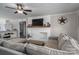 A cozy living room features a white brick fireplace with wooden mantle and comfortable seating at 396 Tower Rd, Vale, NC 28168