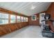Enclosed sunroom with brick walls, wood accents, and multiple windows for natural light at 396 Tower Rd, Vale, NC 28168