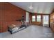 Enclosed sunroom featuring brick walls, wood accents, and a treadmill for exercising at 396 Tower Rd, Vale, NC 28168