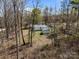 Aerial view of the house and outbuildings surrounded by mature trees at 404 Forest Winds Dr, Salisbury, NC 28144