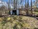 View of the backyard with sheds, mature trees and natural landscape at 404 Forest Winds Dr, Salisbury, NC 28144