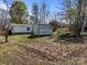 Spacious backyard with white house, outbuilding and mature trees at 404 Forest Winds Dr, Salisbury, NC 28144
