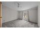 Bedroom with a neutral color scheme, a window with curtains, ceiling fan and carpet at 404 Forest Winds Dr, Salisbury, NC 28144