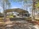 View of the carport and a single-story home with a screen porch and wheelchair ramp at 404 Forest Winds Dr, Salisbury, NC 28144